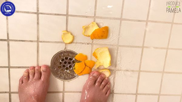 Feet in shower with orange peels